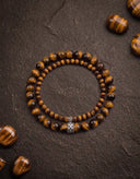 Tigers Eye beaded bracelets on a dark textured background