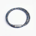 Blue braided leather bracelet with silver clasp overhead view
