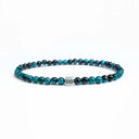 Light blue tiger eye beaded bracelet with a brushed silver logo bead