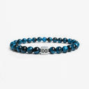 Light blue tiger eye beaded bracelet with a brushed silver logo bead