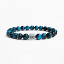 Light blue tiger eye beaded bracelet with a brushed silver logo bead