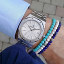 A man wearing Baxter&Baxter bracelets with a luxury watch