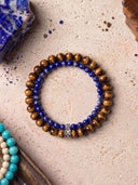 Tigers Eye and Deep Blue bracelets on a textured stone background