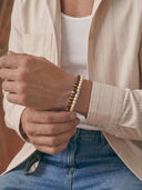 A man wearing bracelets in the 6mm bead size