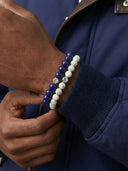 Close-up of a man's hand wearing 8mm gemstone bracelets