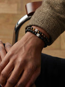 Close-up of a man wearing gemstone bracelets with brushed silver Sylfren beads