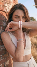 A woman posing with gemstone jewellery in the Suffolk countryside—the birthplace of Baxter&Baxter