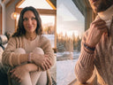 A split lifestyle image showing a woman and a man wearing colourful gemstone bracelets. The woman is seated indoors by a window with a snowy forest view, wearing a beige knit cardigan and cream turtleneck, accessorised with Rose Quartz and Ivory beaded bracelets.