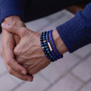 A close-up of a wrist wearing a Cobalt Blue Woven Leather Bracelet