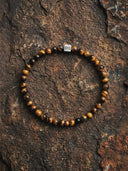 Tigers eye bracelet on a textured stone surface