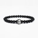 Black onyx beaded bracelet with a silver skull motif
