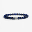 Blue tiger eye beaded bracelet with a brushed silver logo bead
