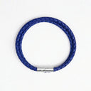 Cobalt blue braided leather bracelet with silver clasp overhead view