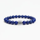 Blue lapis lazuli beaded bracelet with a brushed silver logo bead