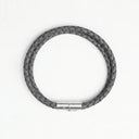 Grey braided leather bracelet with silver clasp overhead view