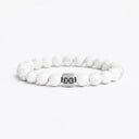 White howlite beaded bracelet with a brushed silver logo bead
