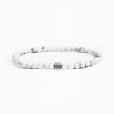 White howlite beaded bracelet with a brushed silver logo bead
